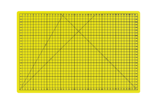 A3 size yellow cutting mat with black measurement grid is isolated
