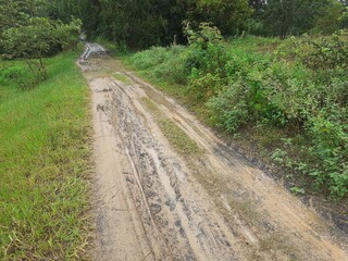 The dirt road turns into mud after the rain.