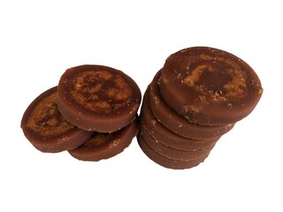 Heap of palm sugar isolated on white background, also known as red coconut sugar or coconut sap sugar. Palm sugar is a sweetener that comes from various types of palm trees.