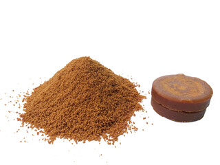 Heap of palm sugar isolated on white background, also known as red coconut sugar or coconut sap sugar. Palm sugar is a sweetener that comes from various types of palm trees.