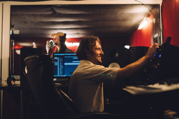 Sound engineer working in recording studio with singer performing