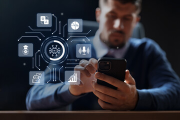 Business professional using smartphone while engaging with technology in modern office environment