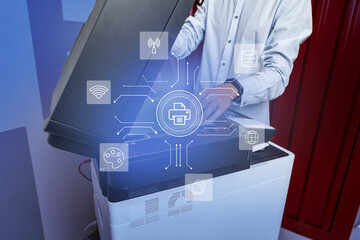 Technician working at a modern multifunction printer in an office environment during daytime, utilizing various digital features
