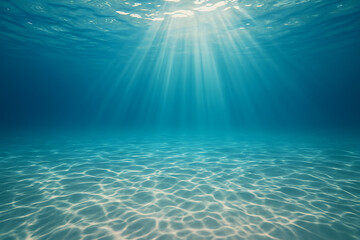 Obraz premium Sunlight Rays Underwater with Clear Blue Ocean and Sandy Seafloor