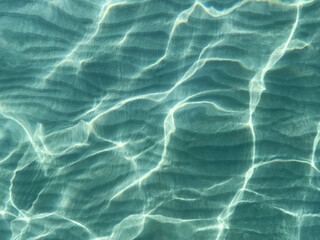 Light reflection on the sea sand bottom through transparent water, Abstract textured background wallpaper © Anastasiia