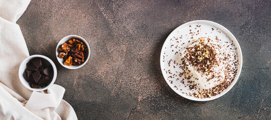 Ice cream bar with chocolate and nuts on a plate on a table top view web banner