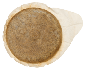 A round coffee pod or single serving of ground coffee wrapped in filter paper.