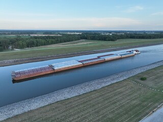 towboat with barges on Chain of Rocks Canal of Mississippi River above St Louis - aerial view