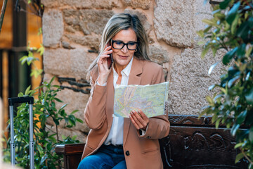 adult woman traveling on the street with map