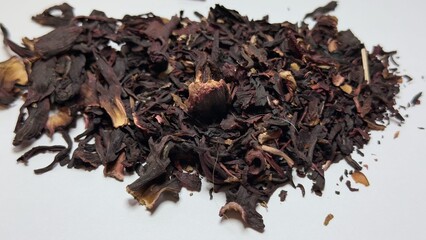 Dried hibiscus petals on white background — natural ingredient for tea, culinary use, and decorative design