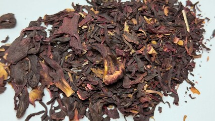 Dried hibiscus petals on white background — natural ingredient for tea, culinary use, and decorative design