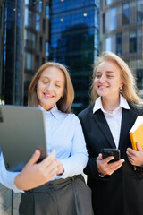 Business partners sharing ideas in a modern urban setting during a sunny day