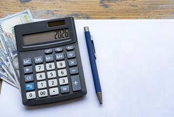 Calculator with the number 2024 on the display US dollars. Concept of finance, taxes, savings and economic crisis.