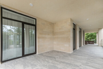 A bright and spacious terrace with modern architectural design, elegant light stone floors 
and a...