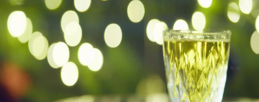 A glass of alcohol on the background of oval side flashing lights