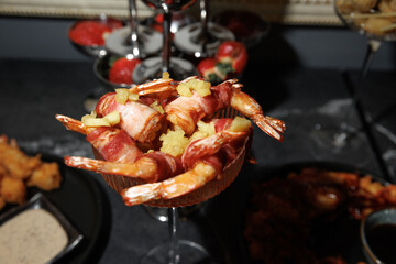 Delicious bacon-wrapped shrimp garnished with pineapple, elegantly presented as a sophisticated appetizer. Perfect for gourmet dining, cocktail parties, or special occasions.