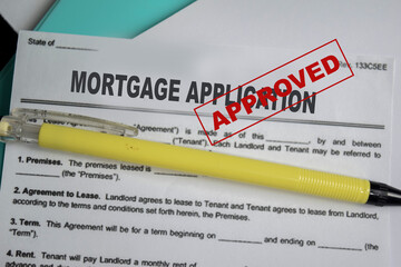 Concept of mortgage application approved form write on document isolated on Wooden Table.