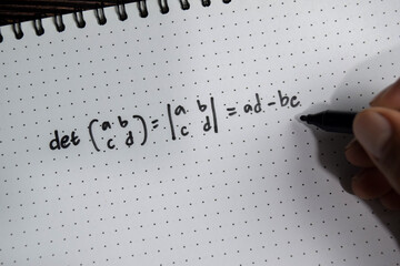 Concept of determinant of a matrix write on book isolated on Wooden Table.