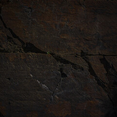 A natural stone texture background with a monolithic rock formation, cracks, and fragments. Ideal for design templates or banners, emphasizing raw, brutal power and natural aesthetics.