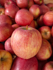 Fresh red apples at a vibrant farmers market in Spain