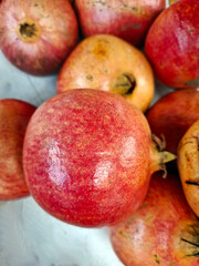 Fresh pomegranate fruits displayed at a vibrant farmers market in Spain during the autumn harvest season