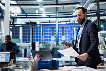Solar tech expert evaluates alternative energy systems in the facility, managing the production...
