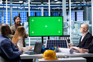 Factory researching team looking at new photovoltaics materials on mockup display. Businessmen in...