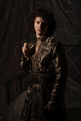Young man in luxurious Arabic-style formalwear with intricate oriental embroidery details