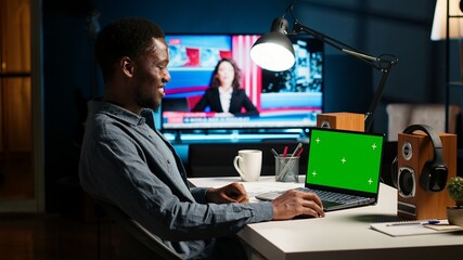 Self employed person checking financial graphs on chroma key screen, researching and sharing...