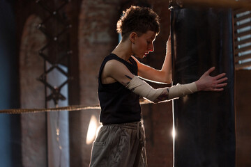 A moment of relaxation before new achievements,concept, sporting achievements, female wrestler in the boxing ring, cinematic look, mood, motivational stories