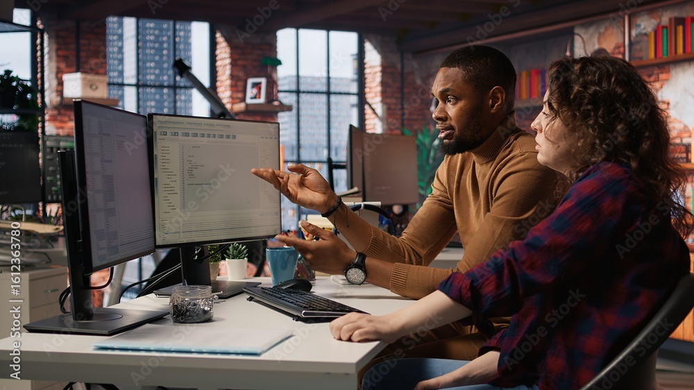 Poster it employees in startup office working at computer desks, testing and deploying programs and systems