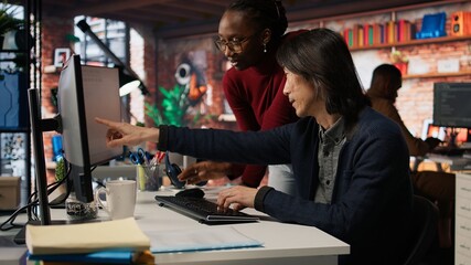 AI startup office admin asks questions to senior team leader before starting implementing machine learning. Tech venture company worker requests help from manager to fix code bugs, camera A