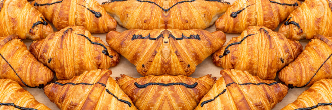 Mini croissant pattern. French puff pastries, chocolat bakery