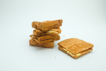 A stack of crispy texture and golden brown color toasted sandwich filled with smooth buttercream isolated on a white background. Perfect for advertisements, packaging, or traditional desserts