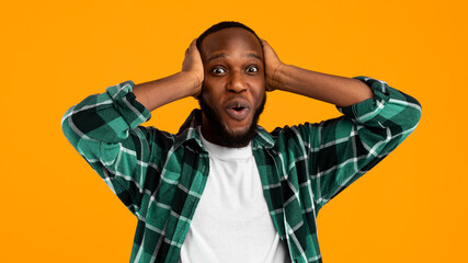 Omg. Surprised African American Guy Touching Head Looking At Camera In Amazement And Shock Posing...