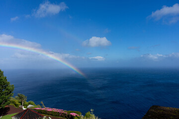 Double rainbow over the Atlantic Ocean at S&atilde;o Miguel Island, Azores, showcasing vibrant colors and dramatic skies above the serene ocean landscape.