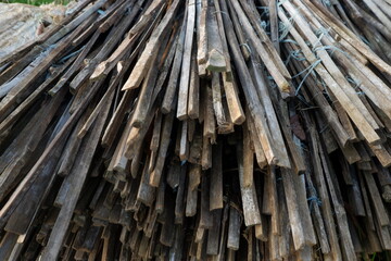 Stack of Wooden Planks Bound with Twine in a Natural Outdoor Setting
