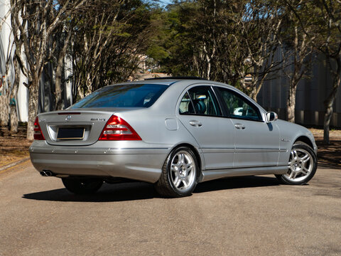 Rear three-quarter view of a silver Mercedes-Benz C32 AMG, Classic German performance sedan


