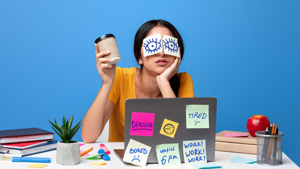 Sleep deprivation, Insomnia. Portrait of exhausted young woman sitting at workplace with stickers...