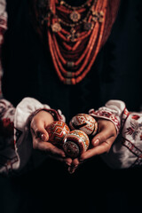Ukrainian woman hand painted Easter egg. Beautiful geometric slavic decoration