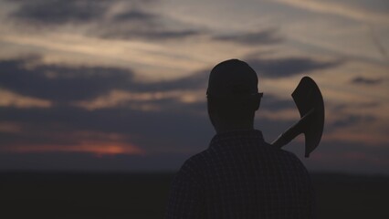 silhouette of a farmer with a shovel, agriculture, go to dig land for garden, preparation for...