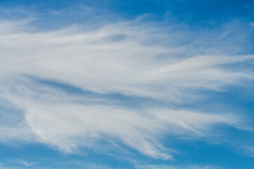 High cloud in the blue afternoon sky