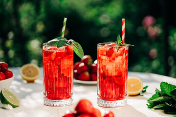 Amazing iced strawberry lemonade drinks. Still life, mojito cocktails for two.