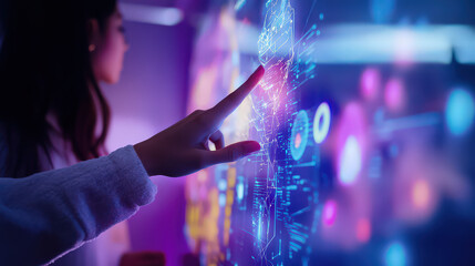 Woman interacting with a futuristic digital interface with glowing blue and purple elements visible