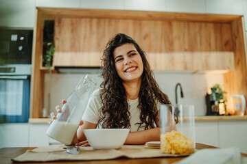 Young caucasian woman eating cereals for breakfast at home	