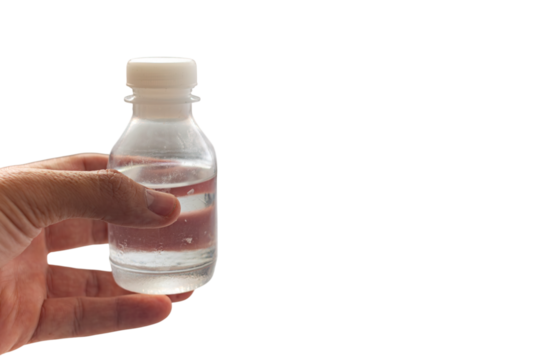 Transparent bottle with clear liquid held by hand – isolated on white background