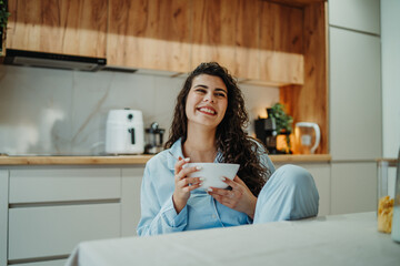 Young caucasian woman eating cereals for breakfast at home	
