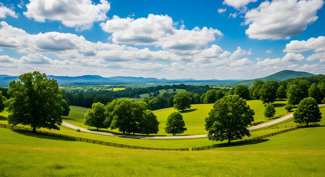 Rolling green hills and lush trees under a bright blue sky with clouds