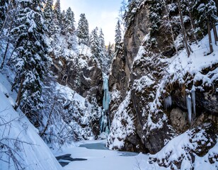 Frozen waterfall in a snowy canyon