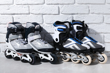 Roller skates on grey marble table near white brick wall